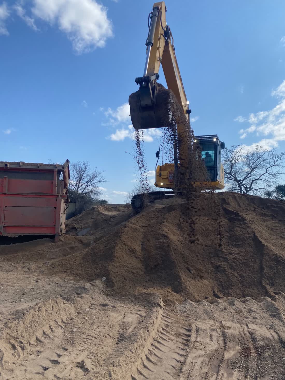 Excavator and front loader parked in the yard