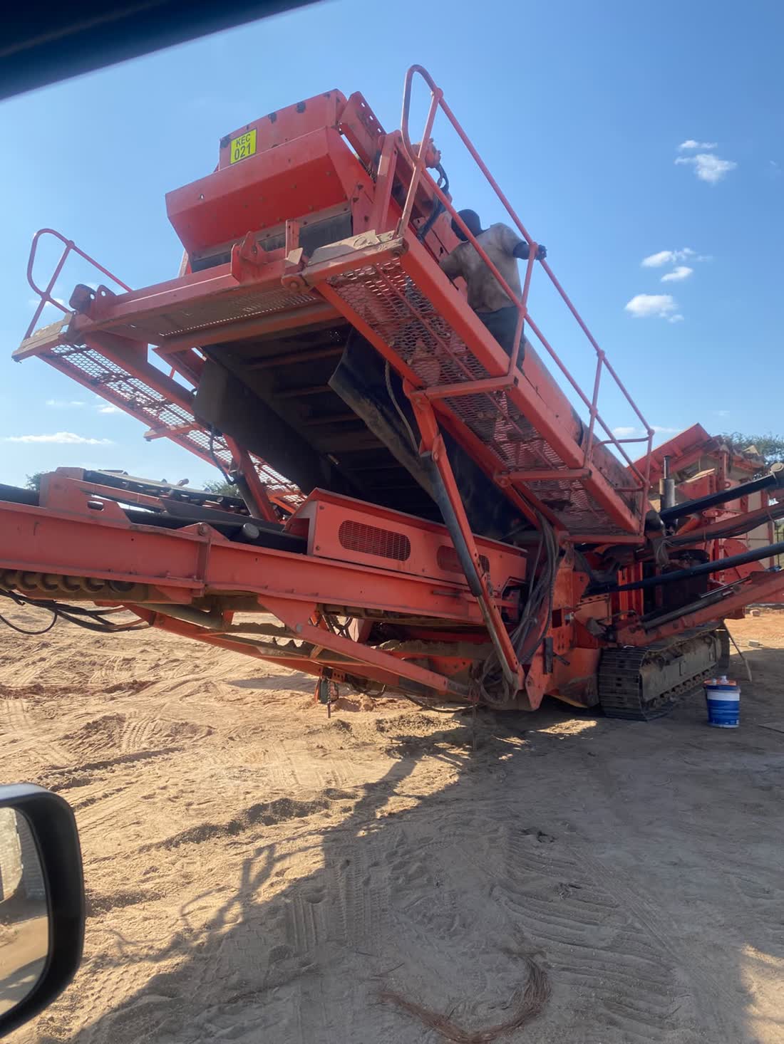 Excavator loading a tipper truck with sand