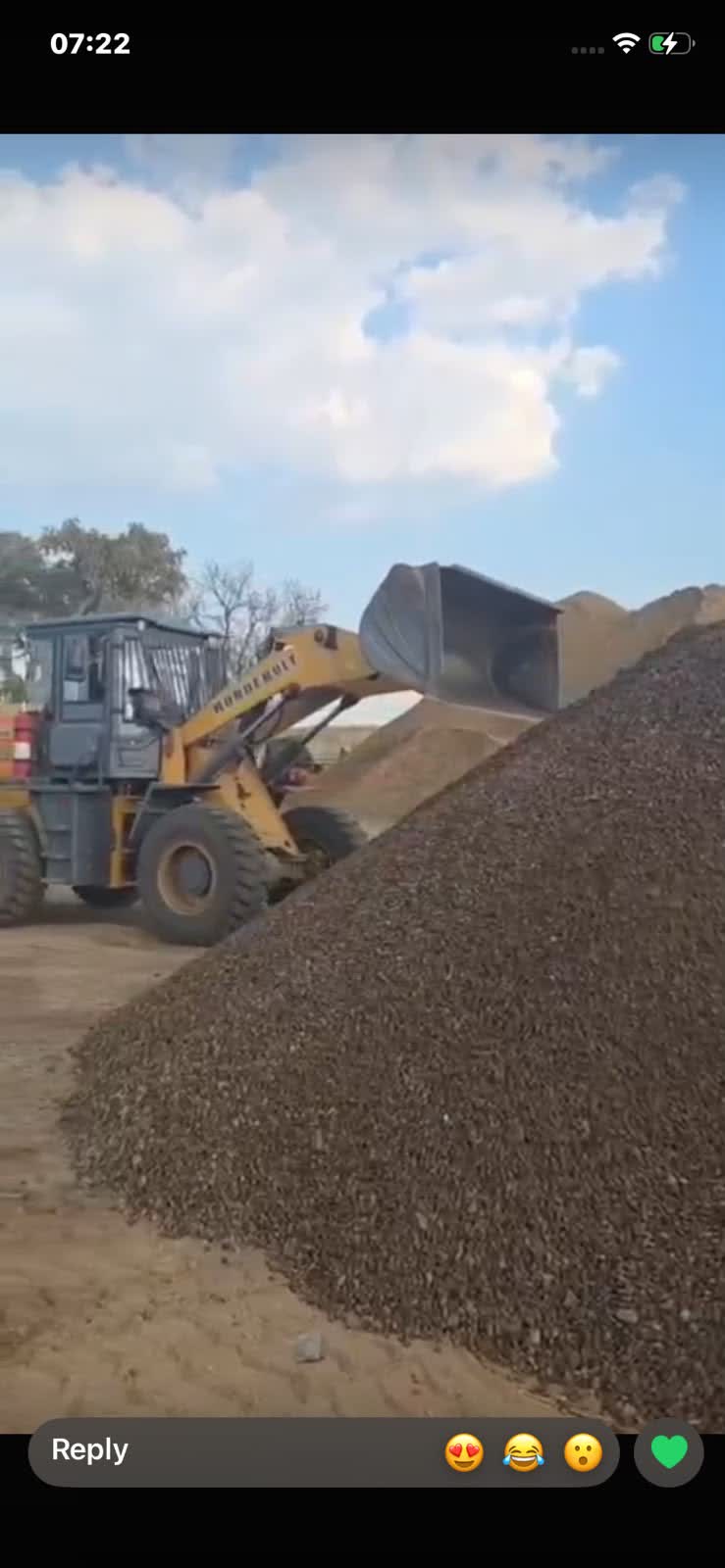 Loader feeding the crusher plant at dusk