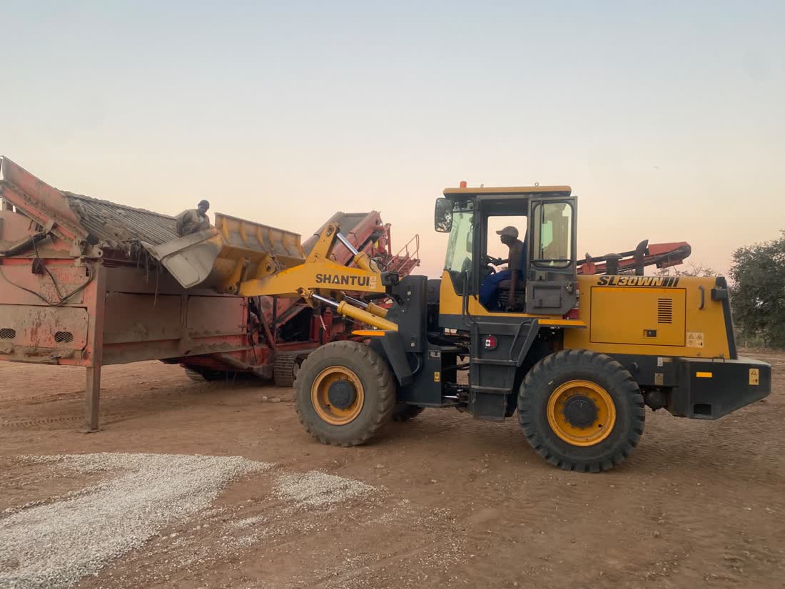 Front loader moving stone at the stockpile